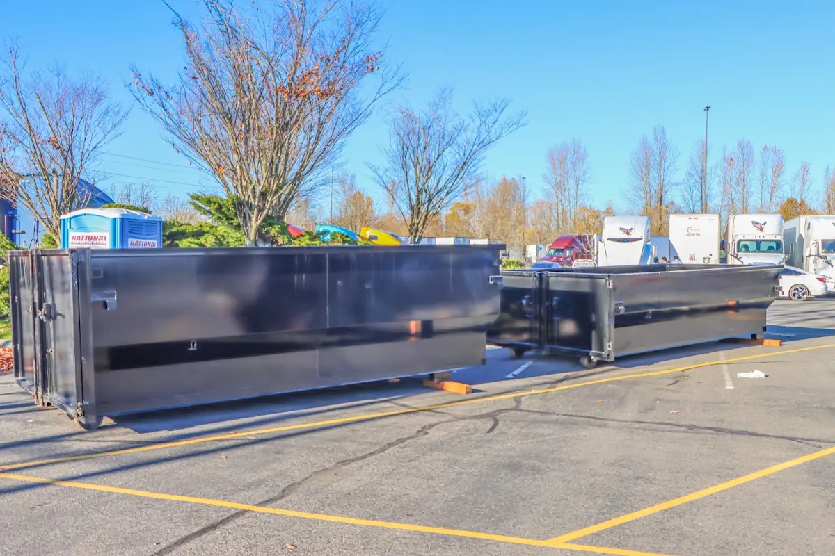 Professional dumpster rental service with roll-off container on residential driveway in Locust